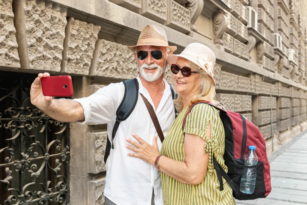 elderly couple taking selfie with phone