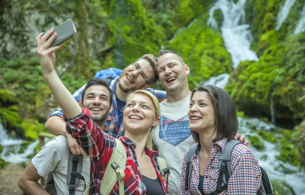 group friends having fun taking selfies nature