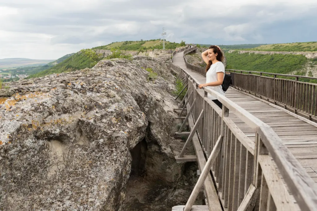 side view woman posing nature bridge