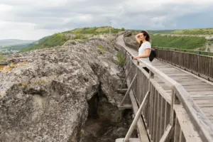 side view woman posing nature bridge