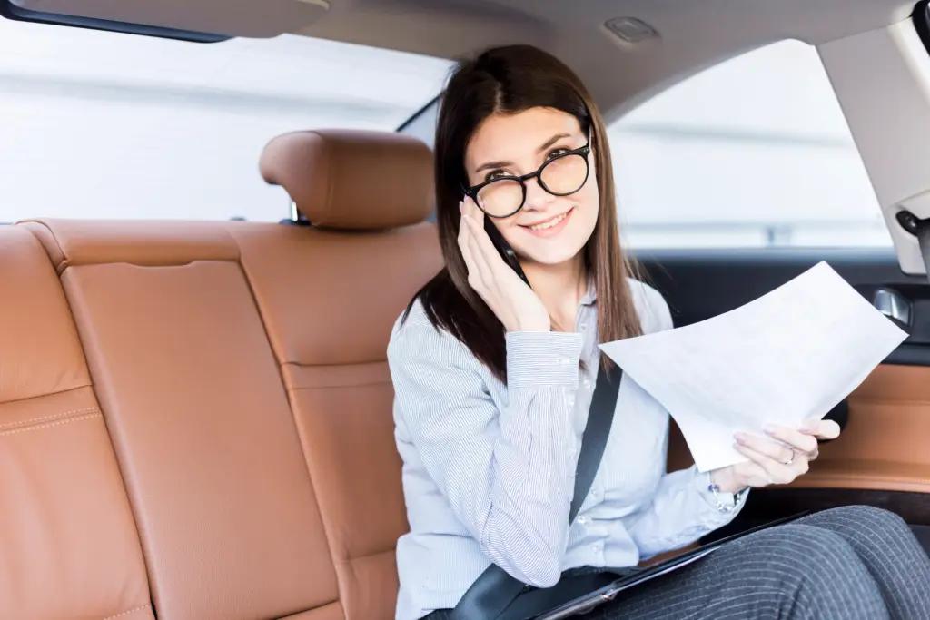 brunette businesswoman posing inside car