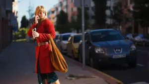 woman with smartphone beverage street