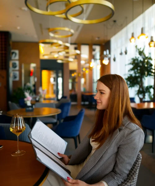 woman looking through menu restaurant scaled.webp