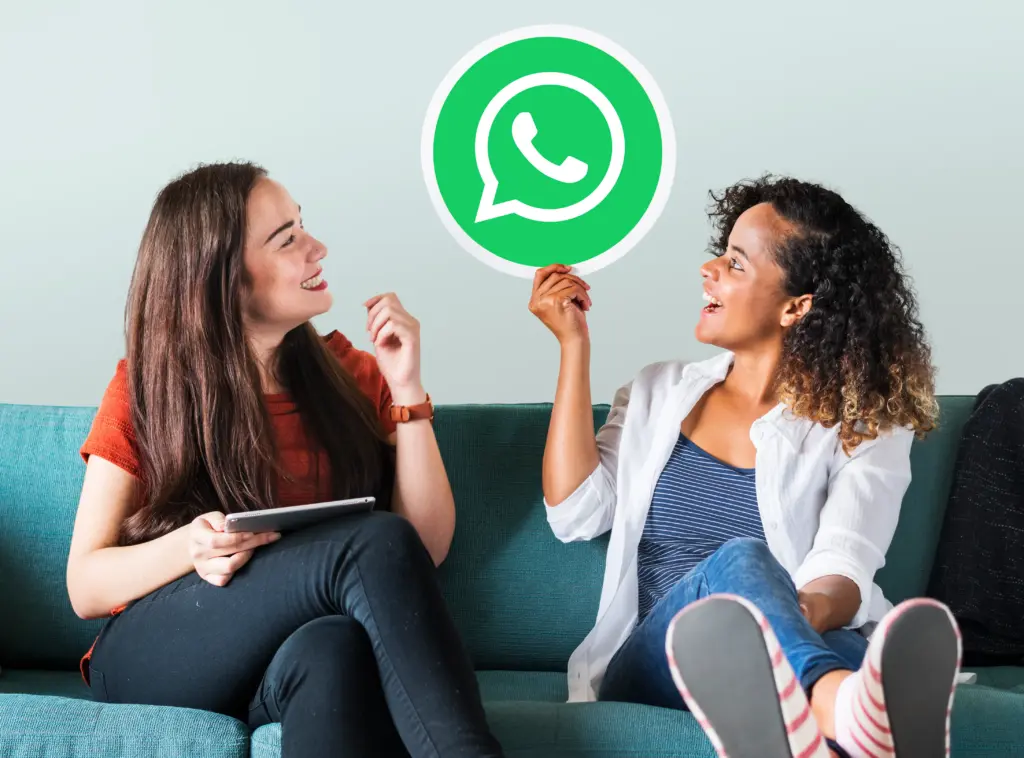 mujeres jovenes mostrando un icono de whatsapp messenger