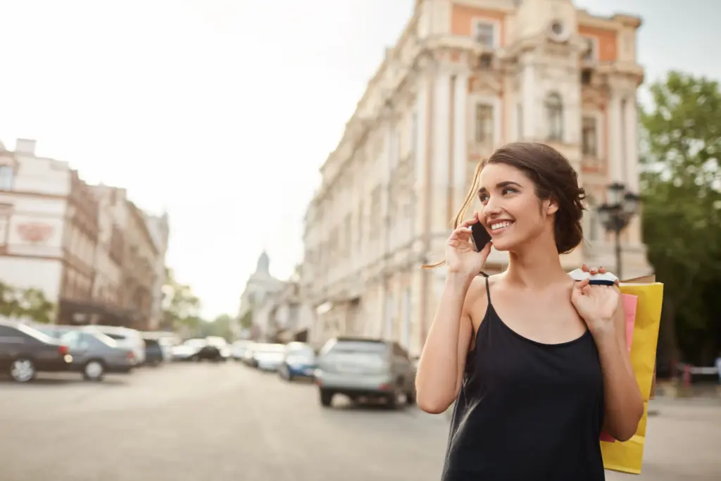 portrait young good looking caucasian woman with dark hair black dress waking around city