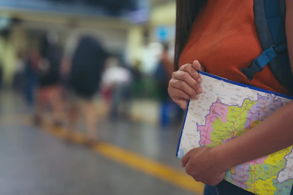 women enjoy traveling map train station