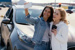 women taking selfie car