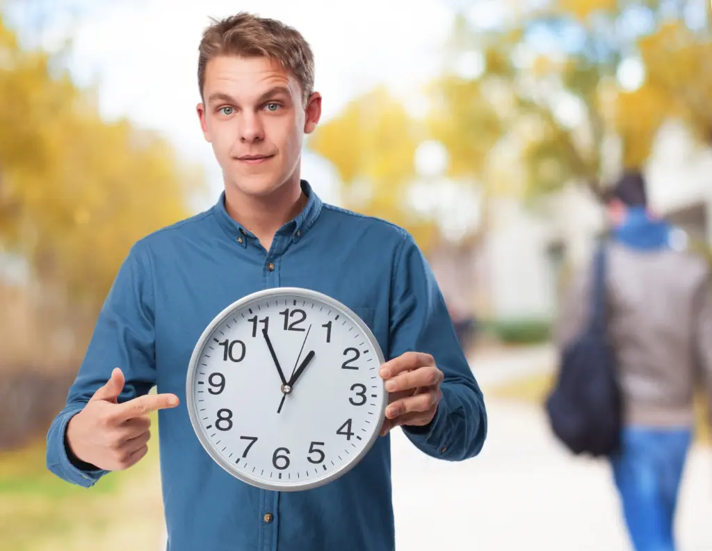 man pointing big clock