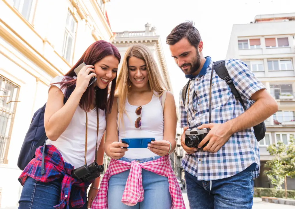 grupo de amigos felices mirando el telefono movil