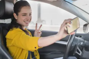 woman taking selfie car